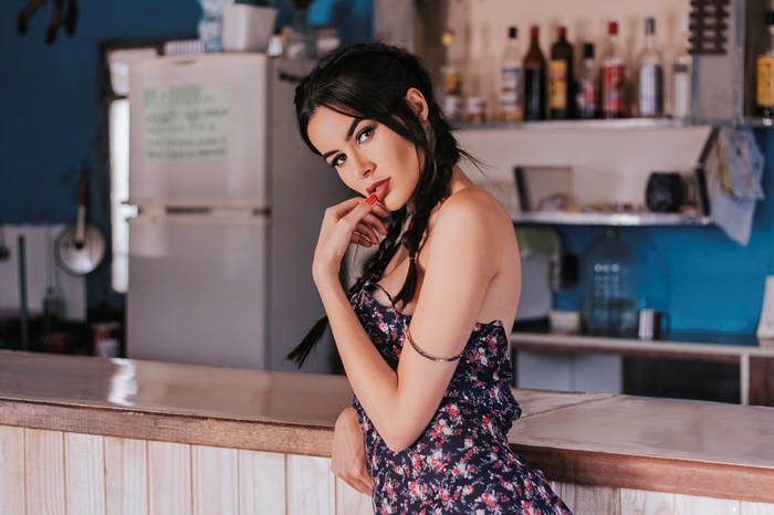 Woman with pigtails and red lipstick at a bar