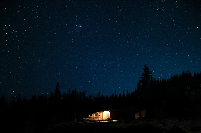 Cabin under a starry night sky