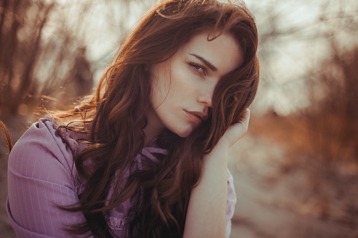 Portrait of a woman with long auburn hair outdoors