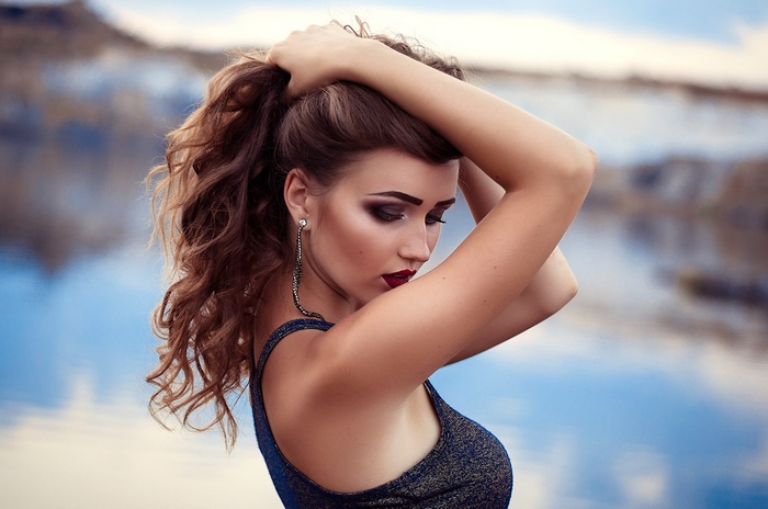Woman with hands in her hair and red lipstick