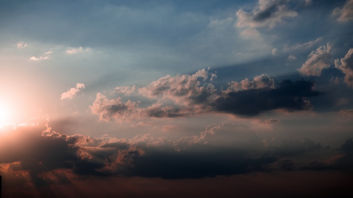 Sun setting behind dramatic clouds