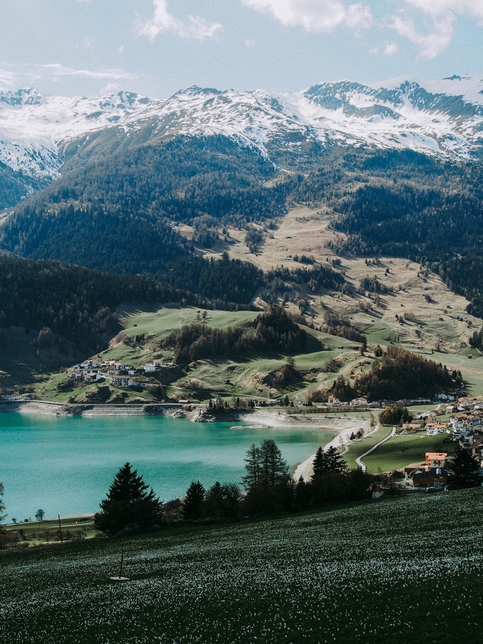 Turquoise lake and snow-capped mountains in the Alps