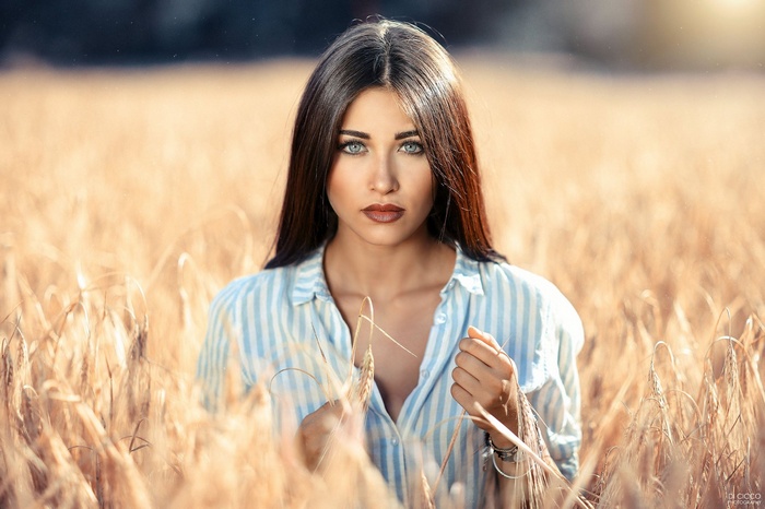 Woman in striped shirt in a wheat field