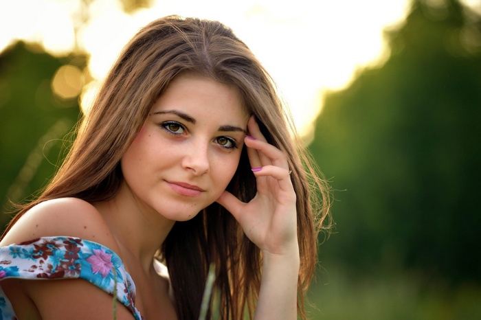 Young woman with long brown hair outdoors