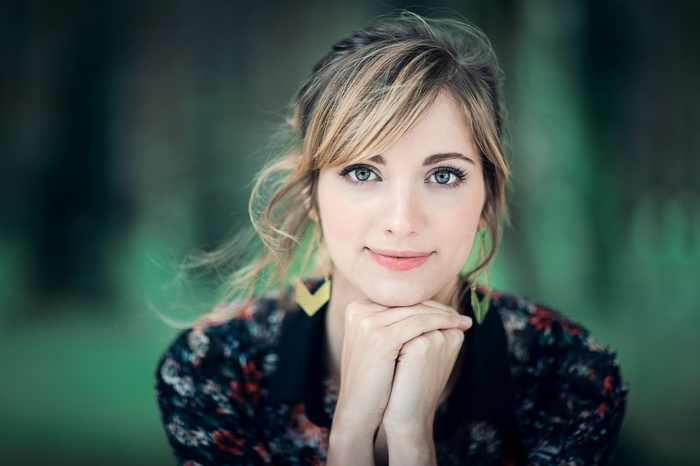 Woman with blonde hair and blue eyes outdoors