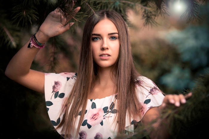 Young woman with long brown hair and blue eyes