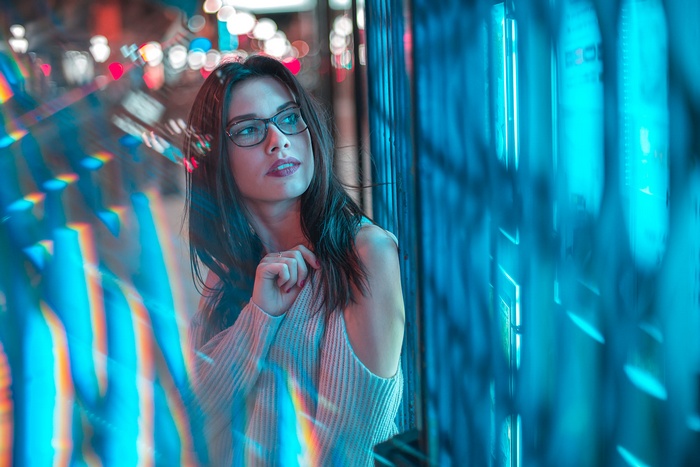 Woman with glasses looking at blue lights