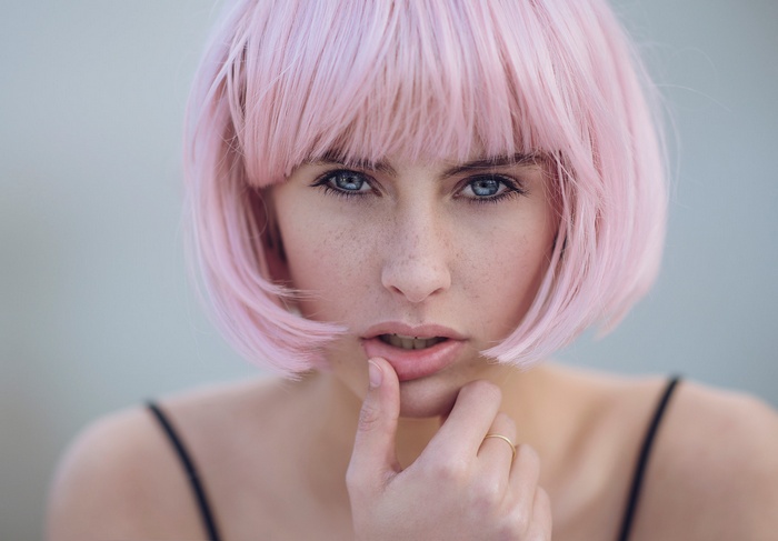 Woman with pink bob wig and blue eyes