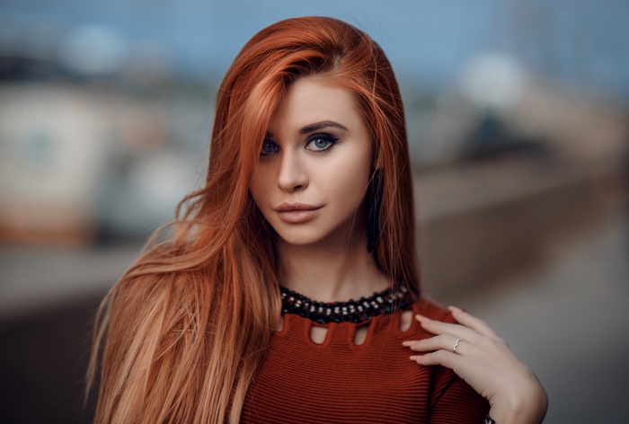 Redhead woman with blue eyes and red dress