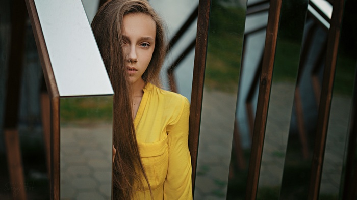 Model with long hair in yellow dress