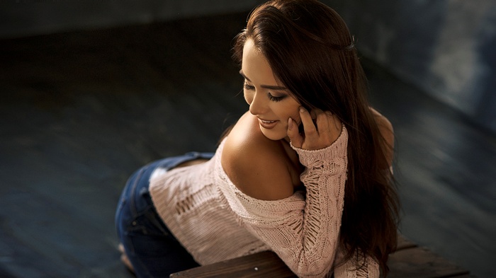 Woman in off-the-shoulder sweater and jeans