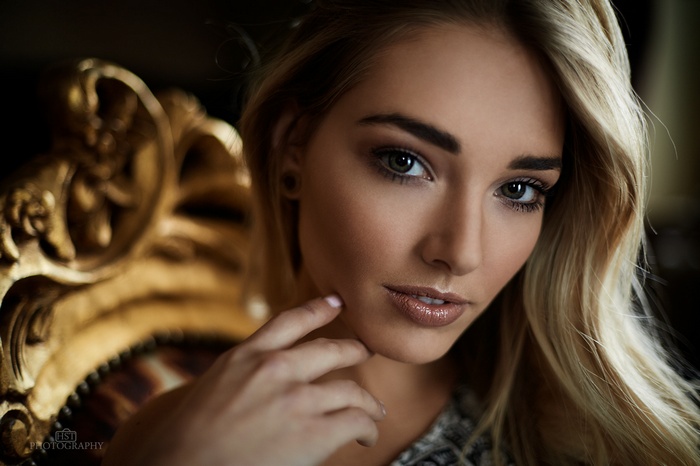 Woman with blonde hair in ornate chair