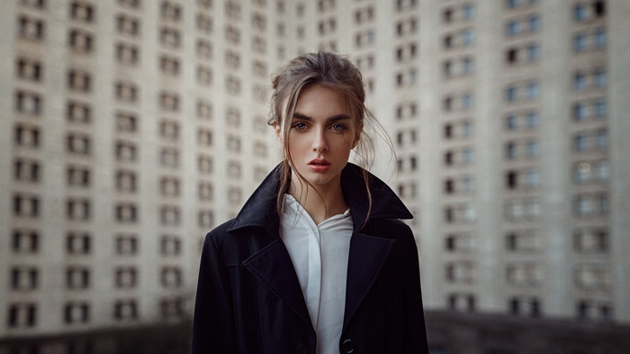 Viktoria Vishnevetskaya in a black coat in front of a building