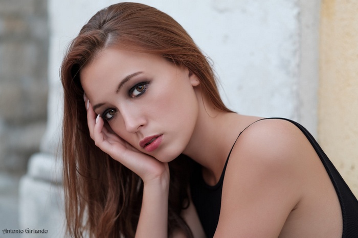 Portrait of a young woman with brown hair and brown eyes