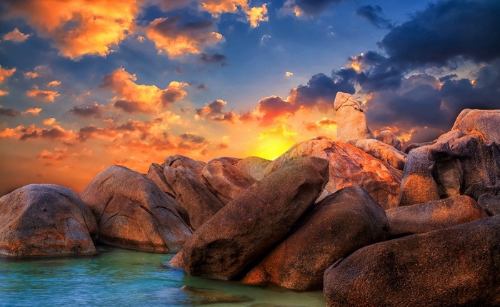 Rocky coast at sunset with colorful clouds