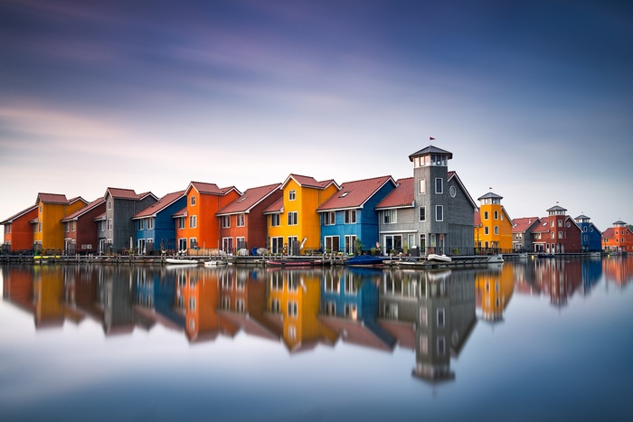 Colorful houses reflected in water