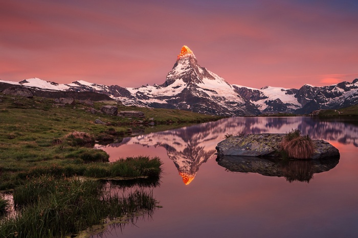 Matterhorn mountain reflected in a lake at sunset