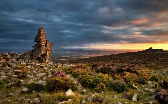 Rocky outcrop at sunset over rolling hills