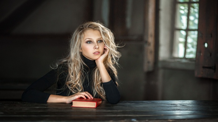 Woman with blonde hair and a book
