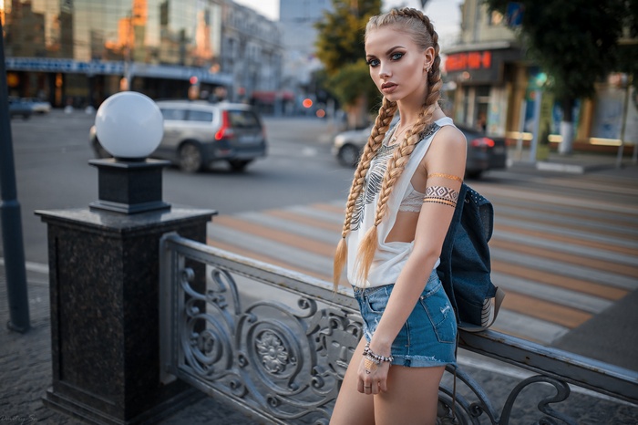 Woman with blonde pigtails wearing jean shorts outdoors