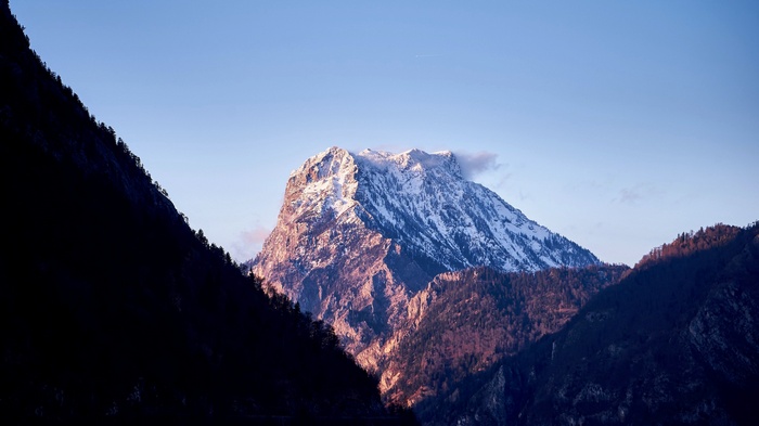 Snow-capped mountain peak at sunset