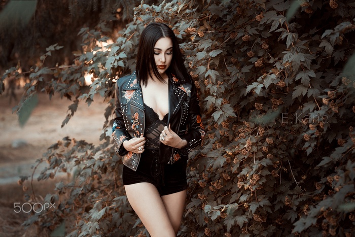 Woman in leather jacket with floral embroidery