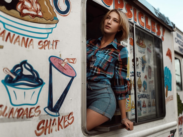 Woman in plaid shirt and jean shorts at ice cream truck