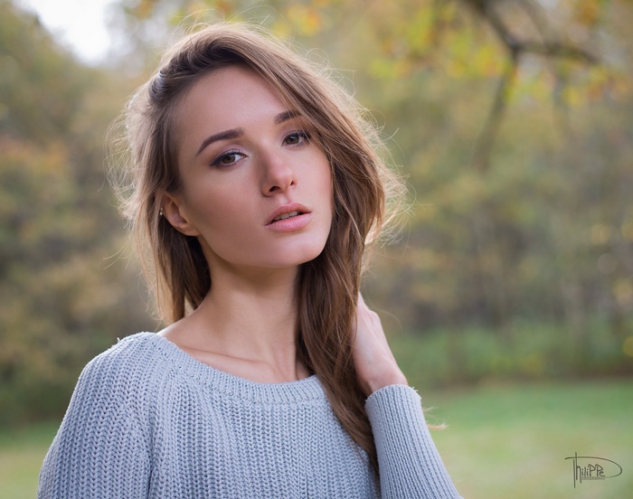 Woman in a light blue sweater outdoors