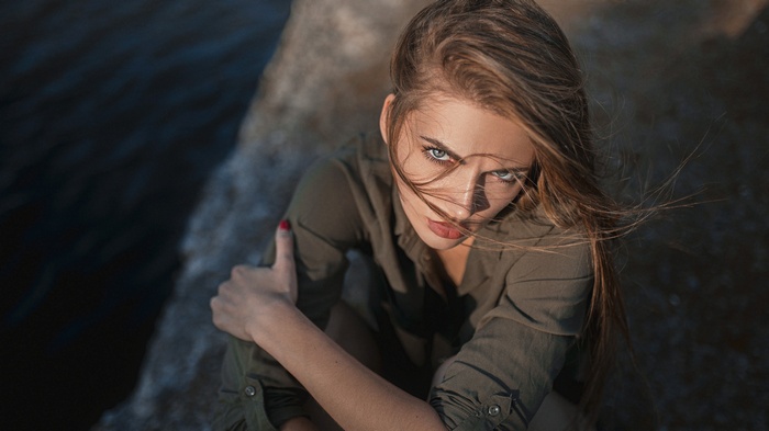 Woman with blonde hair looking up