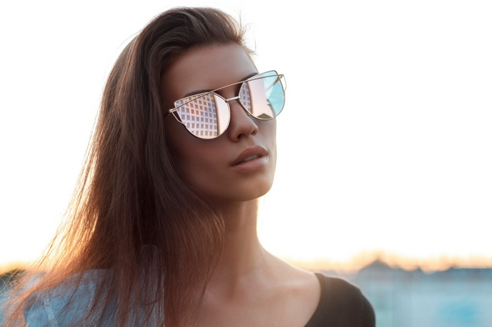 Woman wearing sunglasses with reflections