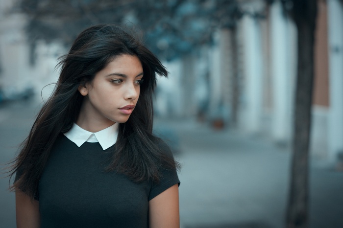 Portrait of a young woman looking away