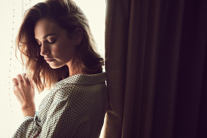 Lily James posing by a window