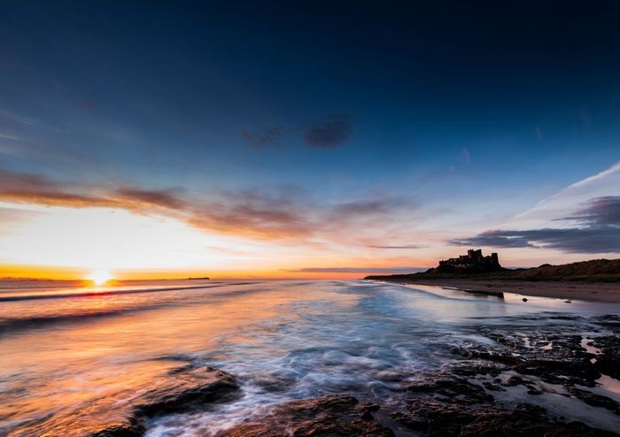 Bamburgh Castle at sunrise on the coast of England