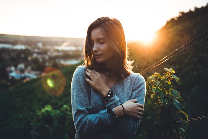 Woman in sweater at sunset