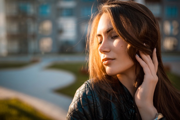 Woman with closed eyes in a leather jacket