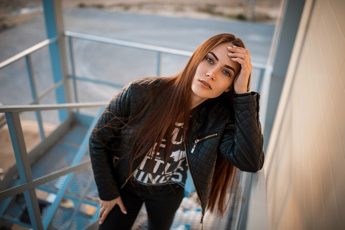 Woman in leather jacket on outdoor stairs