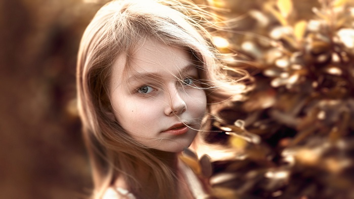 Young girl with blonde hair in the wind