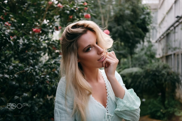 Woman with blonde hair in a garden