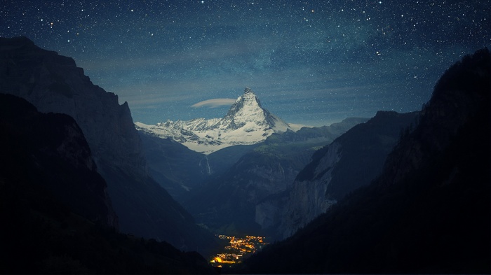 Matterhorn mountain at night with a village below