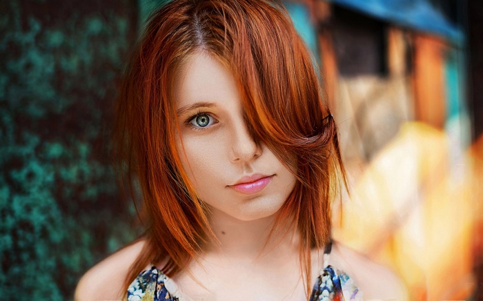 Portrait of a young redhead woman with blue eyes