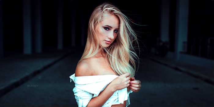 Woman with blonde hair wearing a white shirt