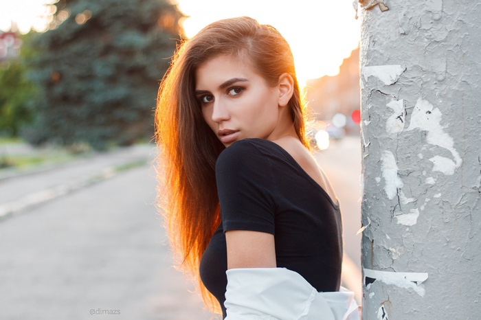 Woman in black top with sunlight on her hair