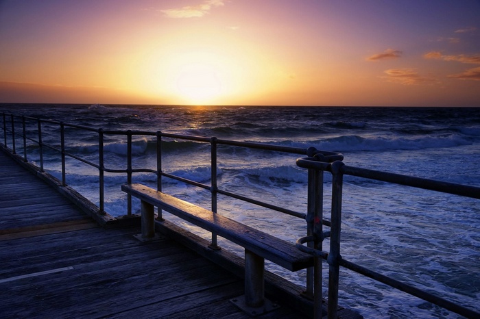 Pier overlooking the ocean at sunset