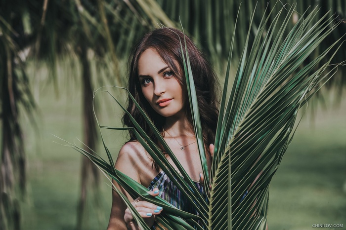 Woman behind palm leaves, Ivan Chinilov