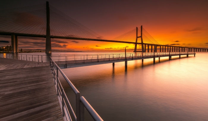Vasco da Gama Bridge over water at sunset