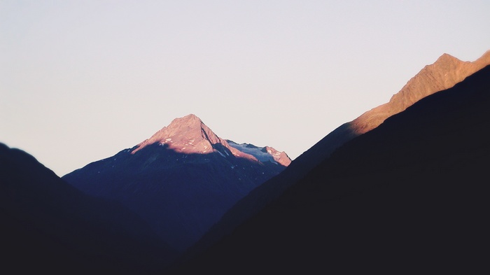 Mountain peaks at sunrise with shadows