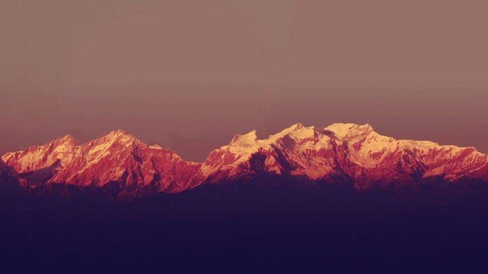 Snow-capped mountains at sunset