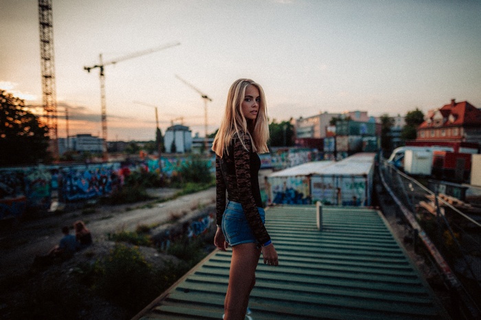 Woman in jean shorts and black top outdoors