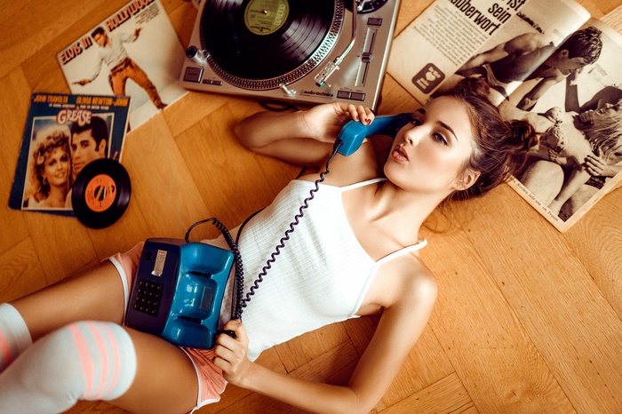 Woman with vintage phone and records