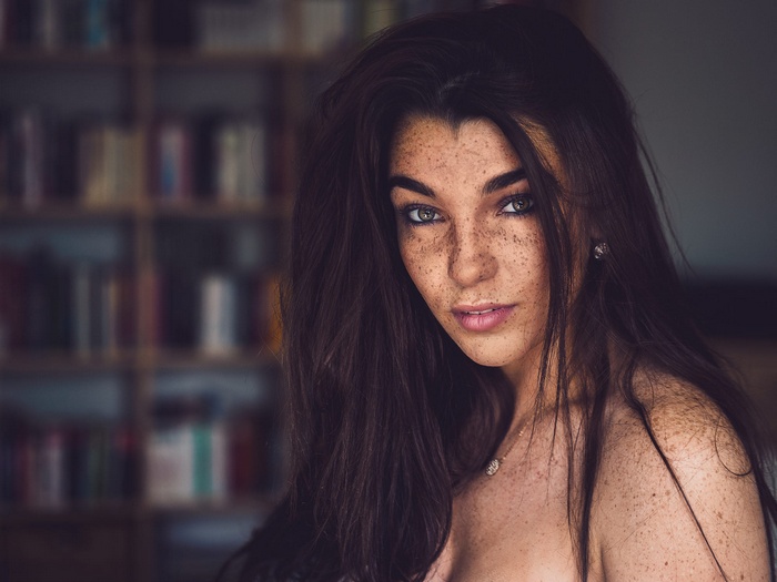 Woman with freckles and long brown hair